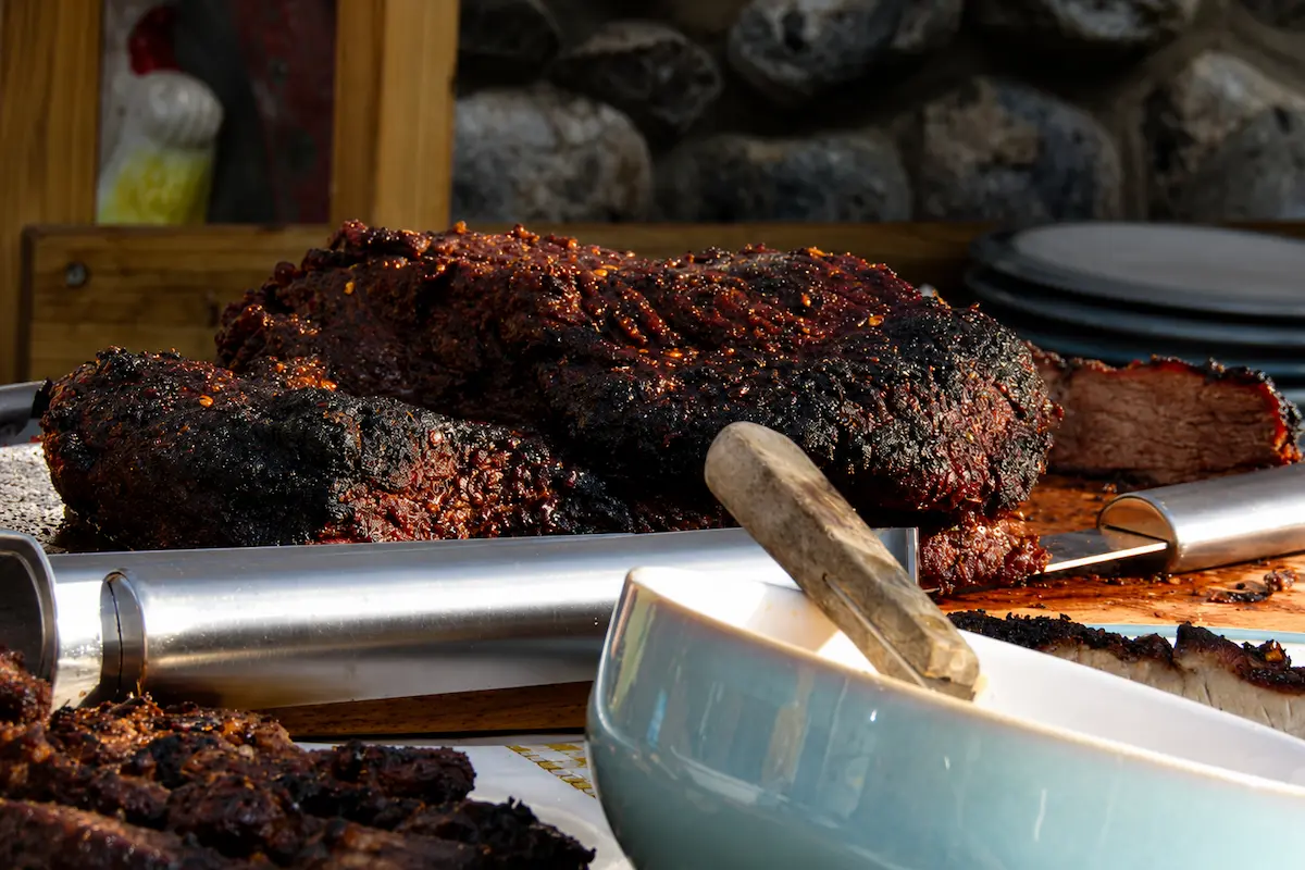 On-site BBQ pit at a graduation party catering setup